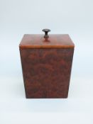 An oak tea caddy with amboyna or similar burr wood veneer,