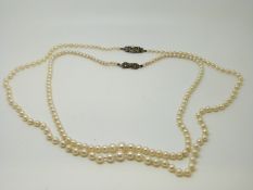 Two pearl necklaces with silver clasps