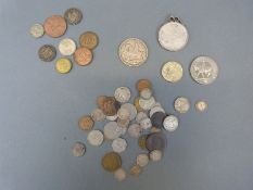 A 1935 George V rocking horse crown together with a collection of silver threepenny pieces,