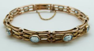 A 9ct gold Edwardian bracelet set with oval aquamarines, 10.