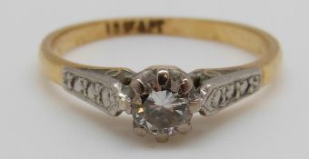 An 18ct gold ring set with a round cut diamond of approximately 0.