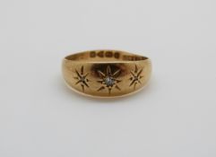 An 18ct gold ring set with three diamonds in star settings, Chester 1916, 3.