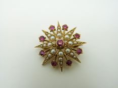 A 9ct gold Edwardian pendant/ brooch set with seed pearls and rubies in a star setting, 2.