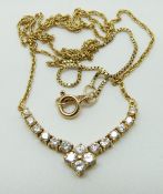 A 10k gold necklace set with diamonds in a V shape, 4.
