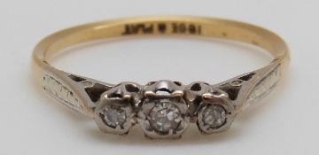 An 18ct gold ring set with three diamonds in a platinum setting, 2.