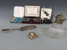 A silver plated and glass jug,