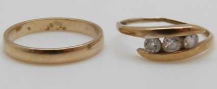 A 9ct gold wedding band and a 9ct gold ring set with cubic zirconia, 3.
