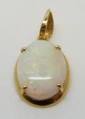 An 18ct gold pendant set with a white opal
