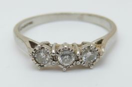 An 18ct white gold ring set with three diamonds, total diamond weight 0.
