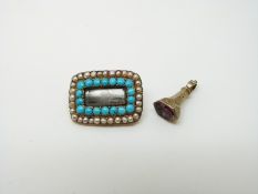 A Victorian mourning brooch set with a row of turquoise and pearls with a small fob