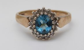 A 9ct gold ring set with blue topaz and diamonds (size J)