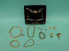 A collection of costume jewellery to include an elephant brooch, swan brooch,