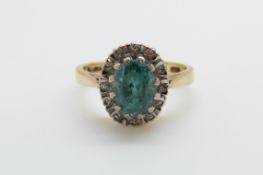 An 18ct gold ring set with a zircon surrounded by diamonds in a platinum setting (size J/K)