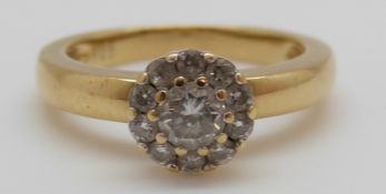 An 18ct gold ring set with a round cut diamond of approximately 0.