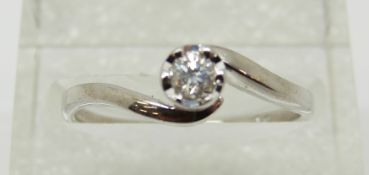 A 9ct white gold ring set with a diamond solitaire of approximately 0.