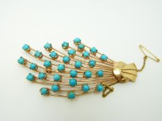 A Persian yellow metal brooch set with turquoise cabochons in a stylised bouquet,
