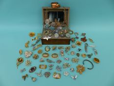 A collection of costume jewellery including paste, lucite brooch, beaded necklaces,