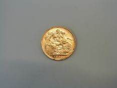 A 1909 gold sovereign,