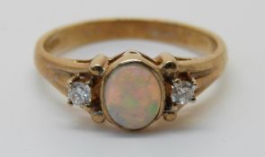 A 9ct gold ring set with an opal and diamonds (size N)