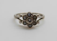 A 9ct white gold ring set with a diamond and seed pearls, 2.