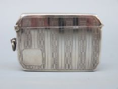 A double sized Art Deco hallmarked silver engine turned vesta with canted corners,