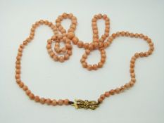 A beaded coral necklace with 9ct gold clasp
