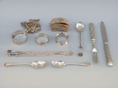 A hallmarked silver and white metal charm bracelet,