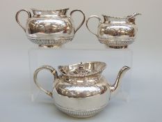 A Victorian hallmarked silver three piece tea set with engraved decoration, London 1878,
