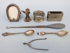 A pair of hallmarked silver novelty sugar tongs formed as a wishbone, silver matchbox holder,