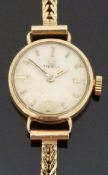 Tissot 9ct gold ladies wristwatch with baton markers and two tone hands, on 9ct gold bracelet,