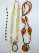 A pressed amber bracelet and necklace and a bone necklace