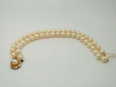A two-strand cultured pearl bracelet with 9ct gold clasp