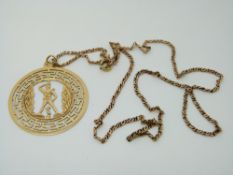 A yellow metal pendant in a Greek style (3g) and a 9ct gold chain (5g)