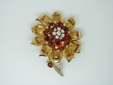 A c1930's Cartier brooch in the form of a sunflower set with old mine cut diamonds to the centre
