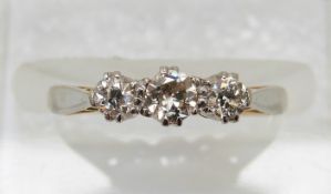 An 18ct gold ring set with three diamonds in a platinum setting, 2.