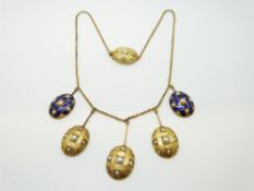 A Victorian yellow metal necklace with five oval drop sections,