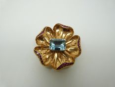 A Tiffany & Co brooch in the form of a flower set with a central emerald cut aquamarine measuring