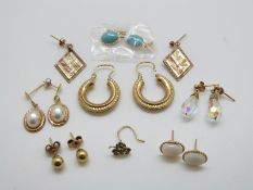 A pair of 9ct gold hoop earrings, a pair of 9ct gold bi-coloured,