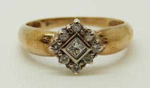A 9ct gold ring set with a square cut diamond surrounded by round cut diamonds, 2.