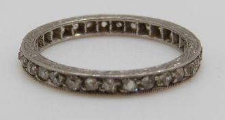A platinum eternity ring set with diamonds (size J)