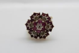 A 9ct gold ring set with diamonds and rubies in a large cluster, 3.