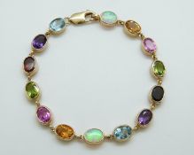 A 9ct gold bracelet set with oval opals, citrines, pink topaz, garnets,