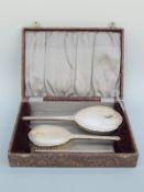 A cased hallmarked silver three piece dressing table set comprising mirror, brush and comb,
