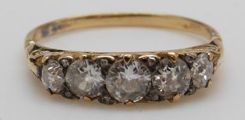 An 18ct gold ring set with five graduated diamonds, the centre diamond approximately 0.