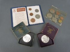 An uncirculated 1953 coronation set of UK coins together with two Festival of Britain crowns (green