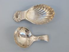 A hallmarked caddy spoon of shell form, Birmingham maker A Maston & Co, together with another,