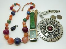 A beaded necklace made up of agate and lapis lazuli, pewter brooch, silver brooch,