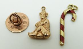A 9ct gold charm in the form of a candy stick set with red enamel,