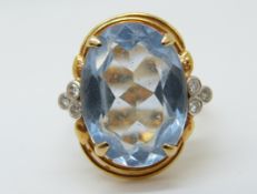 An 18ct gold ring set with a large oval topaz and diamonds (size M)