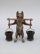 An Austrian cold painted bronze figure of a cat with yoke and buckets, height 8.